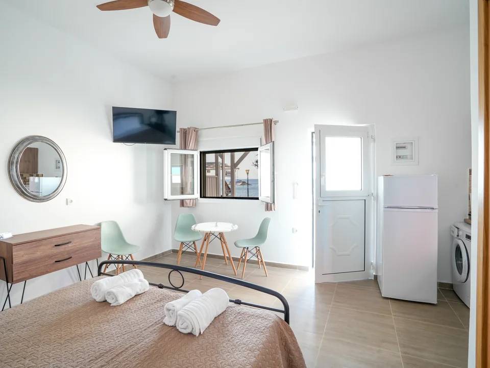 The studio interior with double bed, dining table and kitchenette