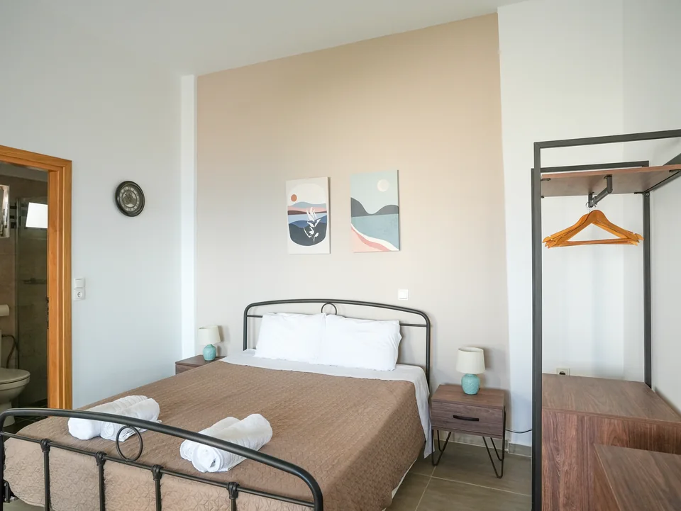 Bed, clothes rail and the door through to the bathroom