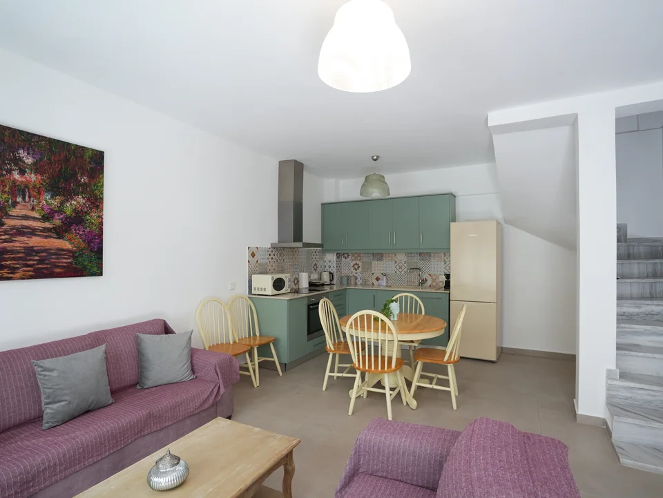 Living area with sofa, coffee table and stairs to the upper floors