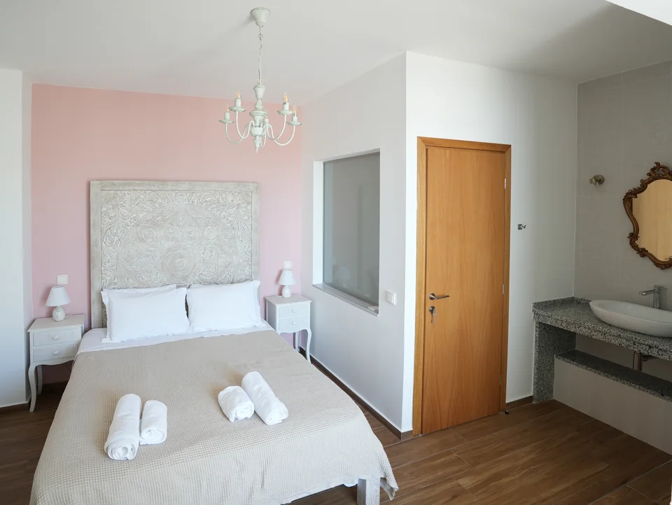 Double bedroom with chandelier and en-suite door