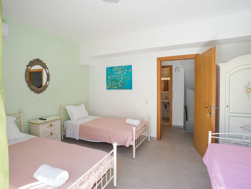 Twin beds with fresh linen and a bedside table