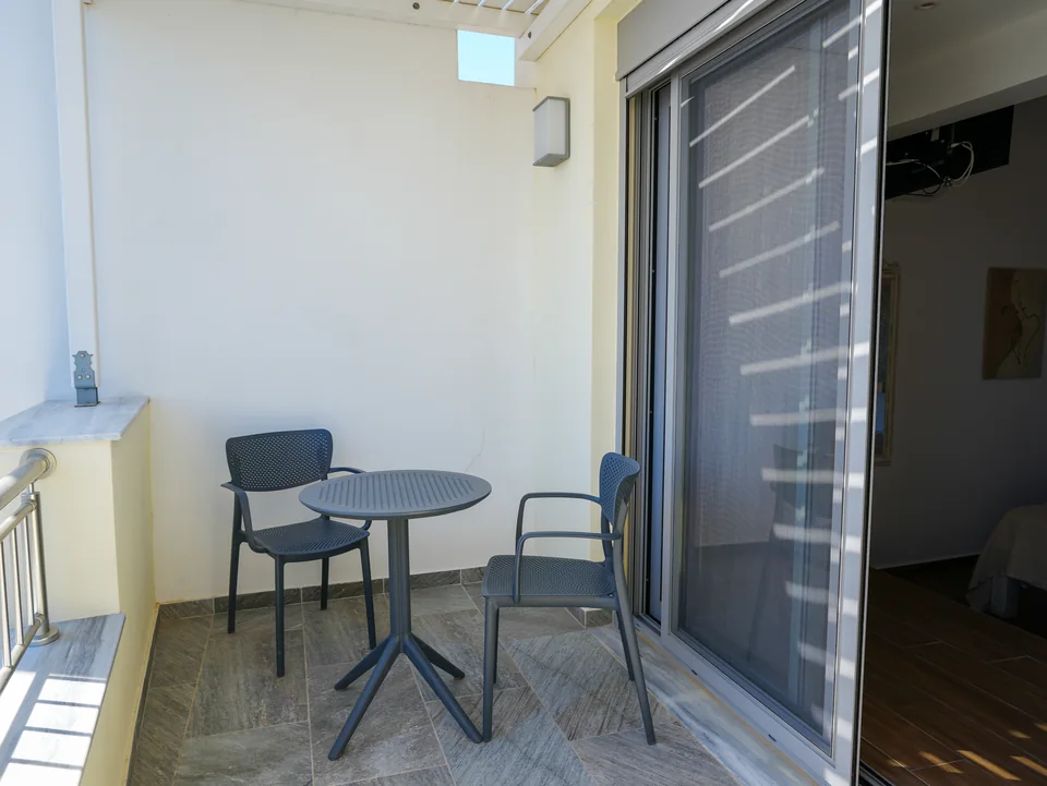 Private balcony with a table and chairs