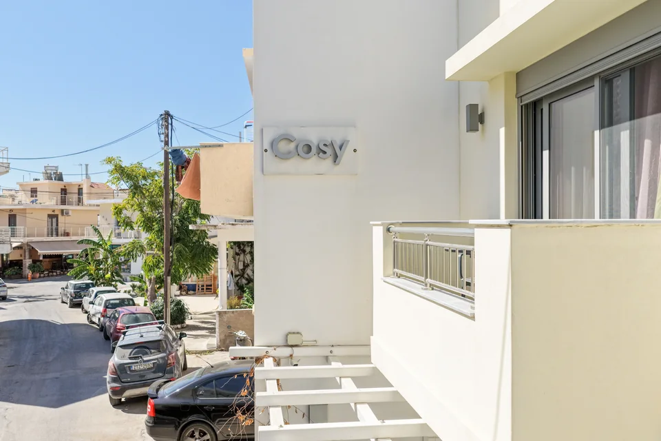 The Cosy house sign on the front of the building