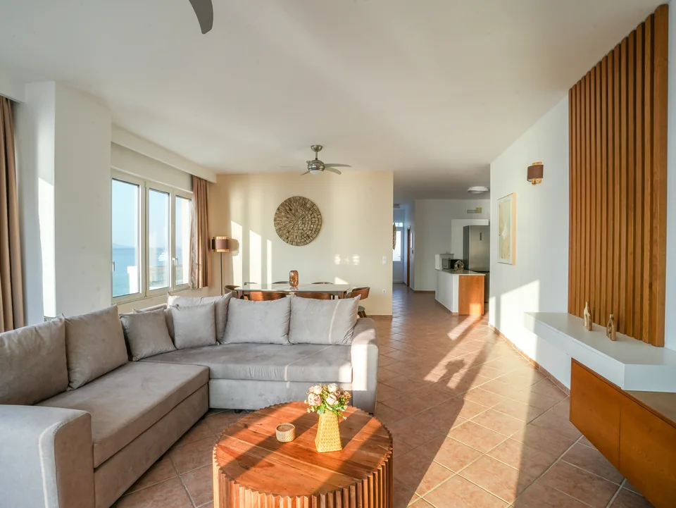Long living space with a wooden slat wall leading through to the kitchen