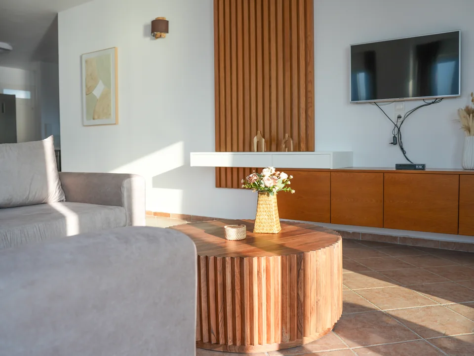 Living room with wooden slat feature wall and sideboard