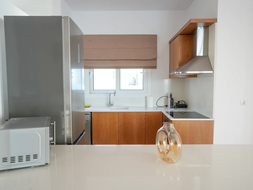 Kitchen worktop with microwave, kettle and marble surface