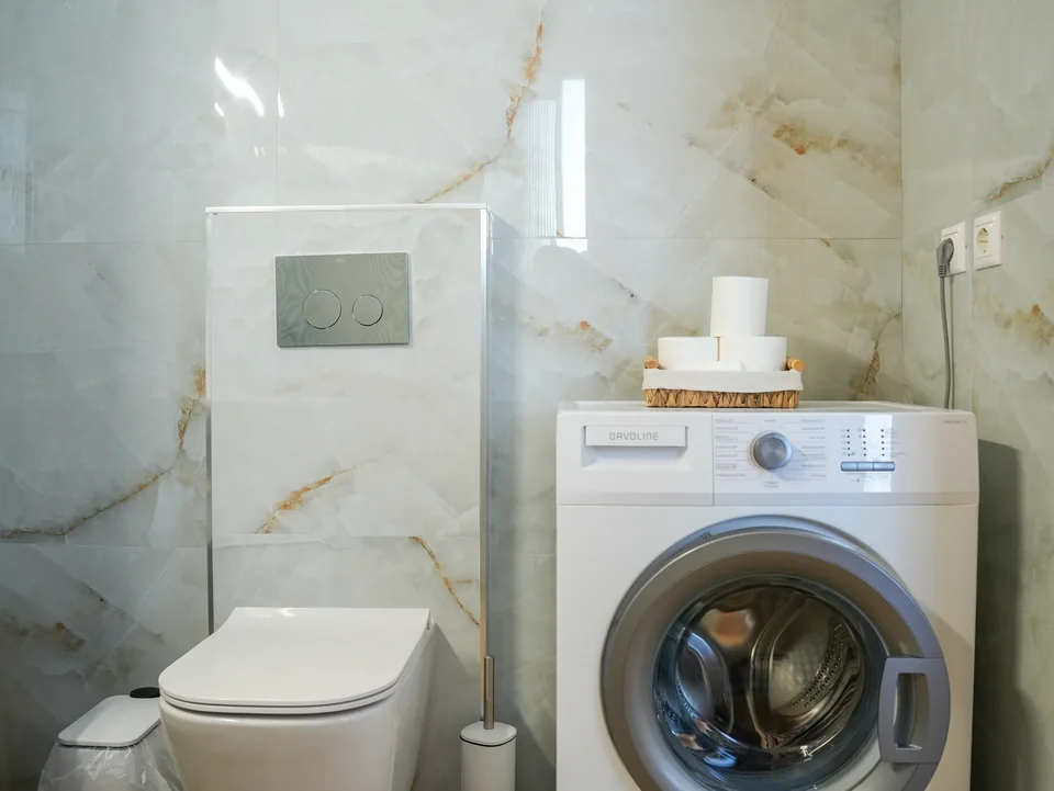 Bathroom with washing machine and WC