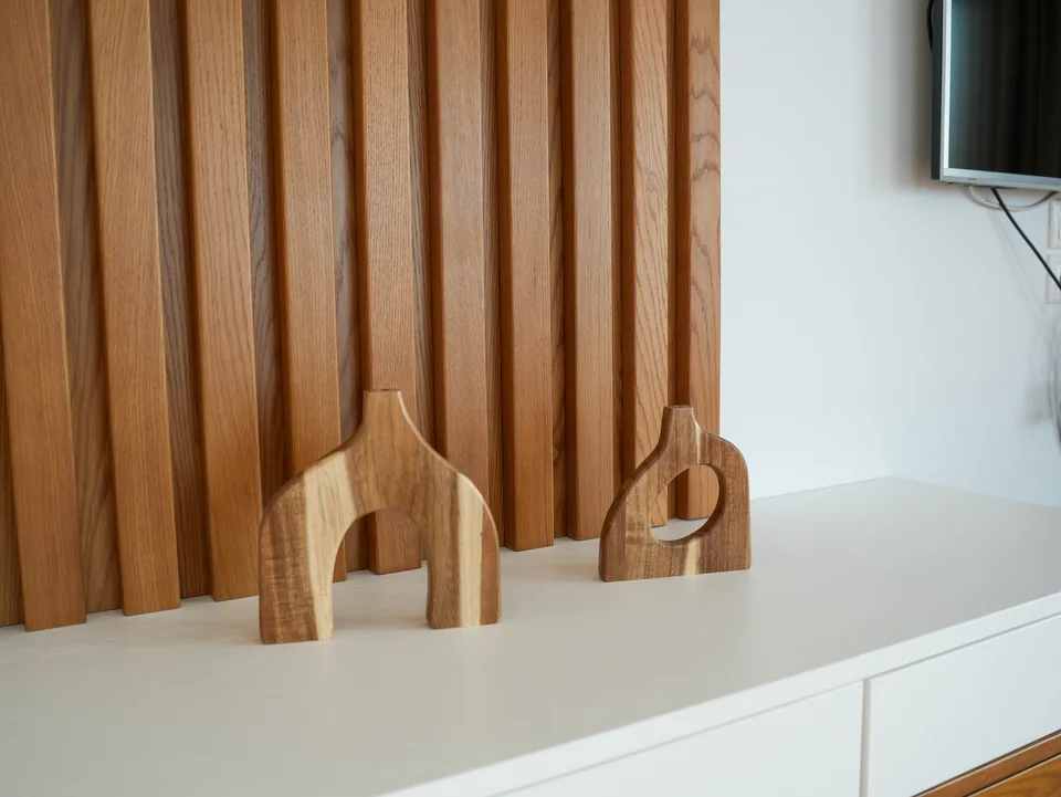 Wooden slat wall detail with television in the living room