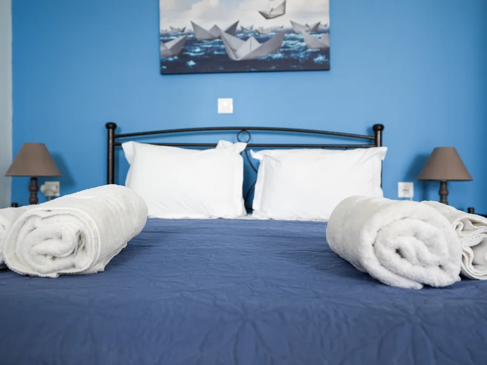 Bed detail with bedside lamps and framed artwork