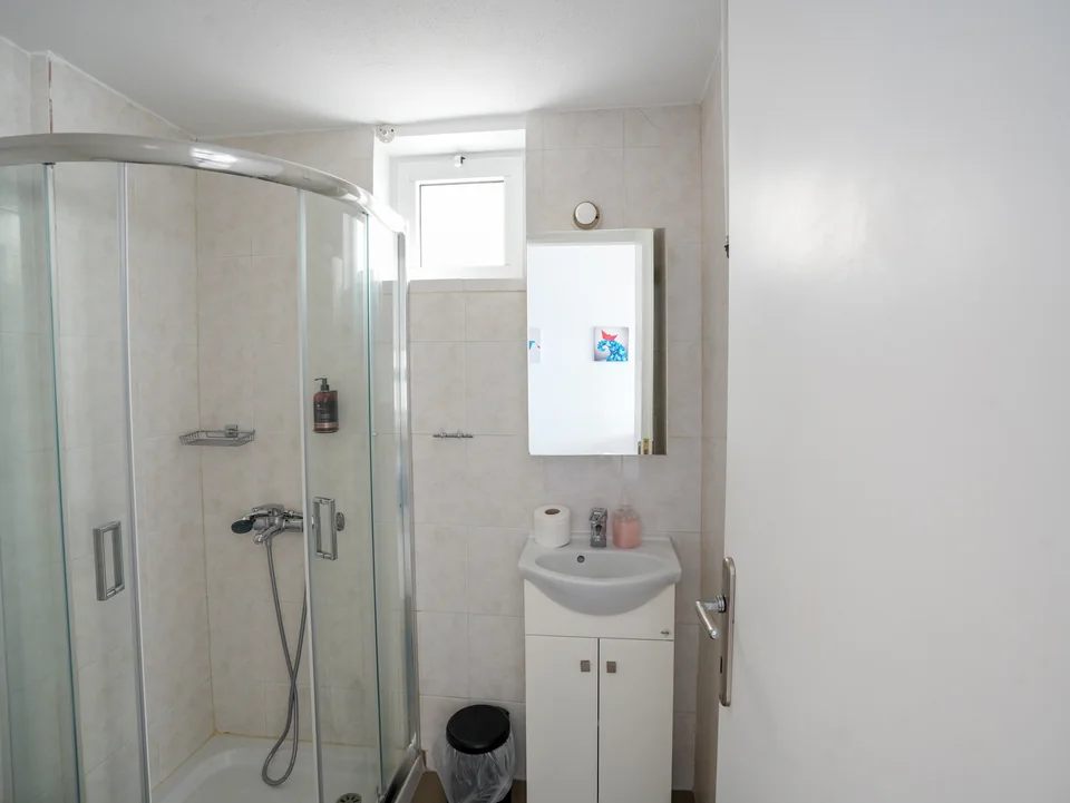 Bathroom with shower cubicle and washbasin